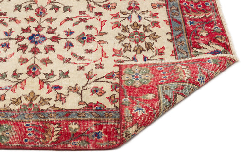 Load image 1 in gallery view. Cream rug with a red, blue, and green floral pattern and a folded corner revealing the underside.