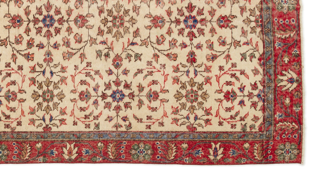 Cream traditional rug with a repeating floral medallion pattern in red, blue, and green, featuring a wide red border.