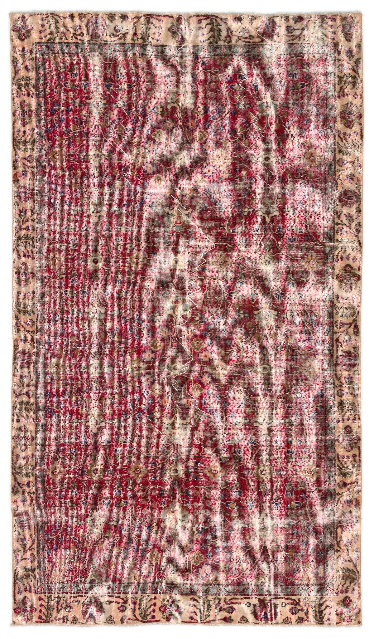 Distressed red and beige traditional rug with a floral medallion pattern and a wide decorative border.