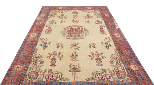 Load image 1 in gallery view. Beige traditional rug with a central red medallion, floral motifs, and a geometric red and blue border.
