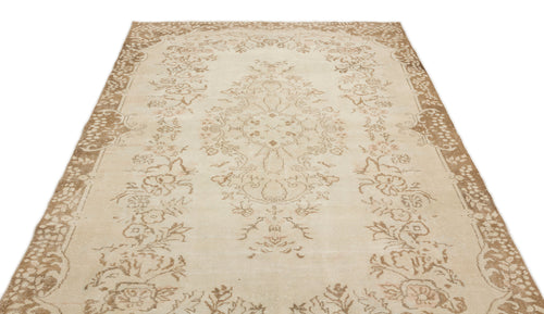 Load image 1 in gallery view. Beige and tan vintage-style rug with a central floral medallion and ornate border on a white background.