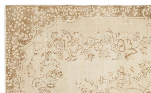 Load image 1 in gallery view. Beige and tan distressed rug with a traditional floral medallion pattern and ornate border.