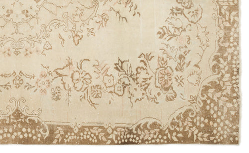 Load image 1 in gallery view. Beige and tan vintage-style rug with a distressed floral medallion pattern and a decorative border.