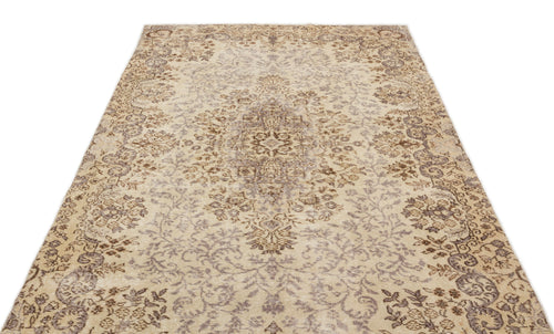 Load image 1 in gallery view. Beige and brown vintage-style rug with a distressed floral medallion pattern on a white background.