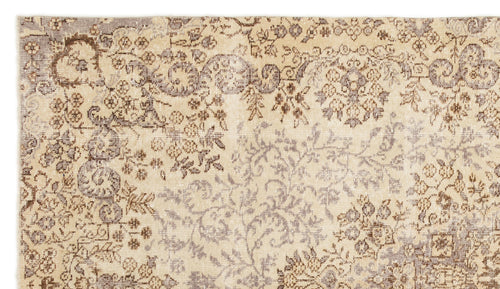 Load image 1 in gallery view. Beige and brown distressed rug with a faded traditional floral medallion pattern.