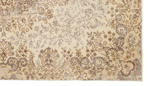 Load image 1 in gallery view. Beige and brown vintage-style rug with a faded floral and vine pattern.