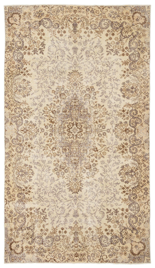 Load image 1 in gallery view. Beige and taupe vintage-style rug with a central floral medallion and intricate botanical border.
