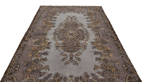 Load image 1 in gallery view. Grey and brown vintage-style rug with a central floral medallion and ornate border pattern on a white background.