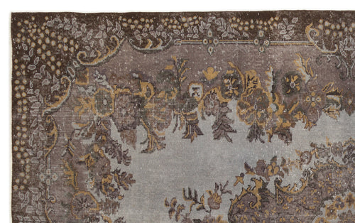 Load image 1 in gallery view. Distressed brown and grey vintage-style rug with a faded floral medallion pattern and ornate border.