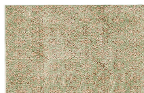 Load image 1 in gallery view. Sage green and beige rug with a repeating floral medallion pattern and a distressed, woven texture.