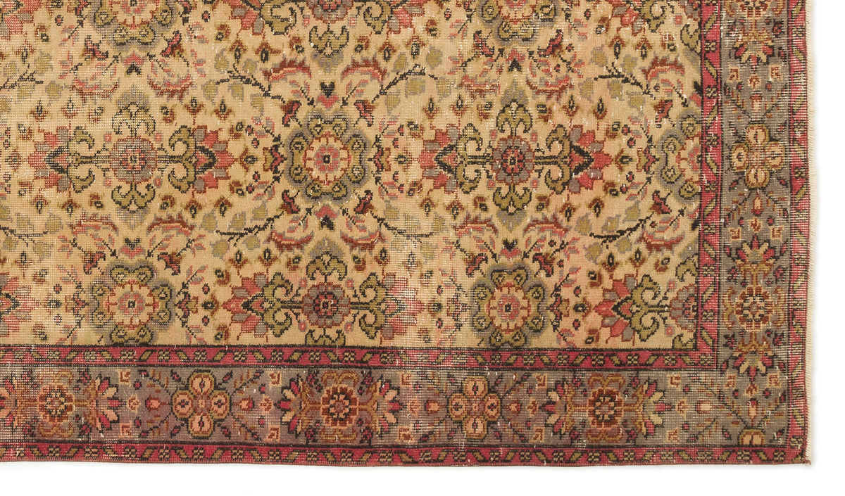 Beige traditional rug with a distressed floral medallion pattern in red, olive green, and charcoal, featuring a border.