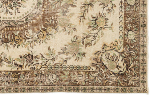 Load image 1 in gallery view. Distressed beige rug with brown and sage green floral medallion pattern and a detailed botanical border.