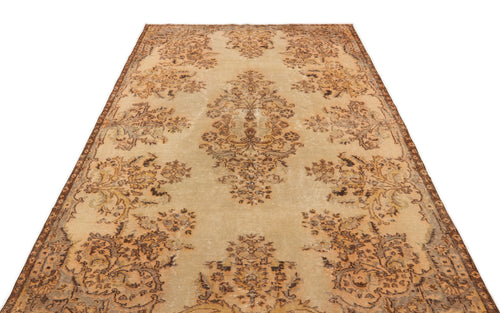 Load image 1 in gallery view. Distressed beige and brown vintage-style rug with a central floral medallion and ornate border pattern.