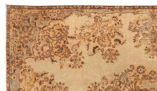 Load image 1 in gallery view. Distressed beige and brown vintage-style rug with a faded floral medallion pattern and a dark decorative border.