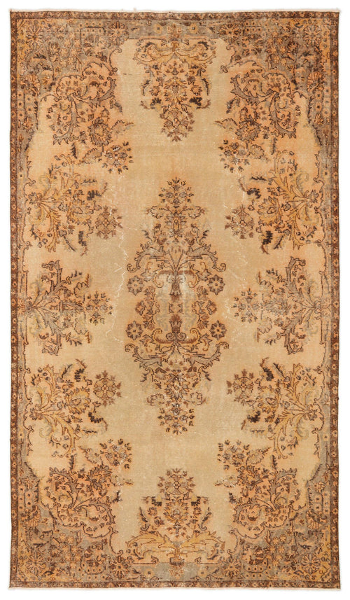 Load image 1 in gallery view. Distressed tan and brown vintage-style rug with a central floral medallion and ornate border pattern.