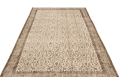 Load image 1 in gallery view. Beige and brown vintage-style rug with an intricate floral medallion pattern and a distressed border.