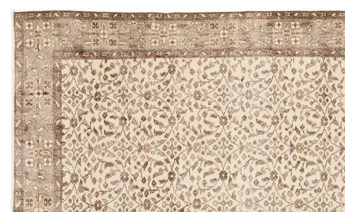 Load image 1 in gallery view. Beige and brown rug with a distressed floral medallion pattern and a wide decorative border.