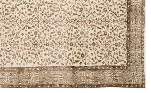 Load image 1 in gallery view. Cream and brown rug with a repeating floral lattice pattern and a wide, detailed border.