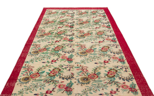 Load image 1 in gallery view. Cream runner rug with a red border and a repeating floral pattern in red, green, and blue on a white background.