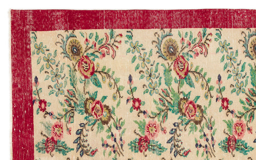 Load image 1 in gallery view. Cream rug with a red border and a distressed floral pattern in shades of red, green, and blue.