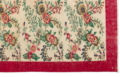Load image 1 in gallery view. Cream rug with a floral pattern in red, green, and blue, featuring a wide red border.