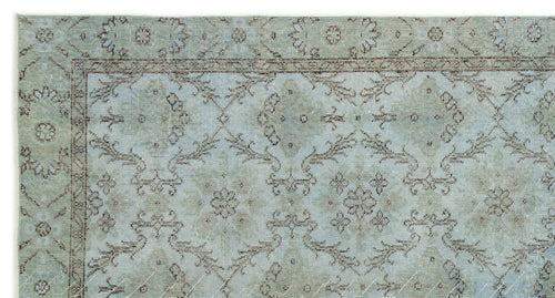 Load image 1 in gallery view. Light blue and sage green rug with a distressed traditional floral medallion pattern and a dark brown border.