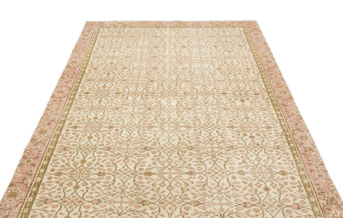 Load image 1 in gallery view. Cream, pink, and tan rug with an intricate floral medallion pattern and a wide decorative border.