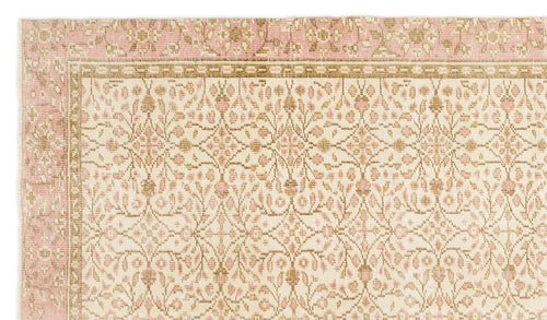 Load image 1 in gallery view. Cream and pink rug with a repeating floral medallion pattern and a geometric border.