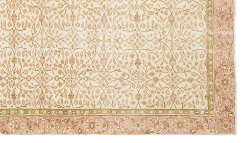 Load image 1 in gallery view. Cream and pink rug with a repeating floral medallion pattern and a decorative border.