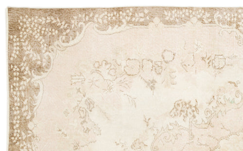 Load image 1 in gallery view. Beige and cream rug with a faded, traditional floral medallion pattern and a decorative border.