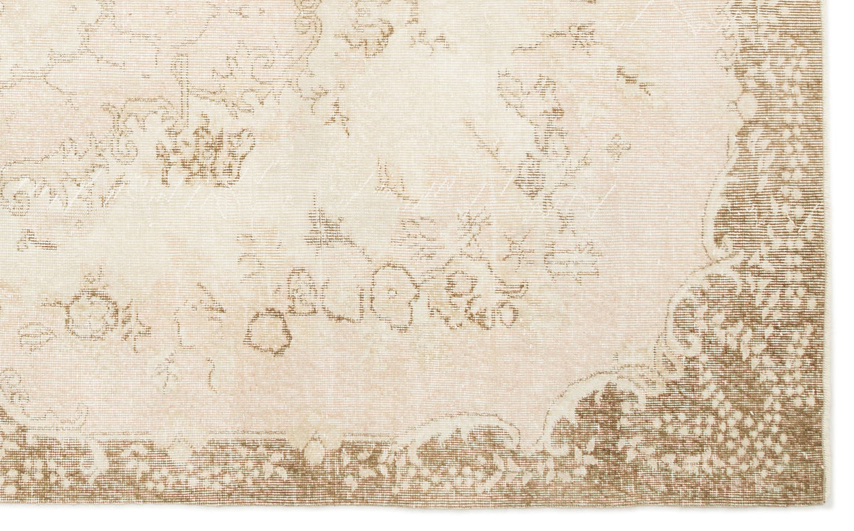 Beige and cream rug with a faded, distressed traditional floral medallion pattern and a wide decorative border.