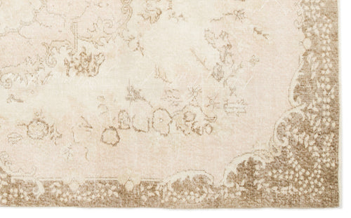 Load image 1 in gallery view. Beige and cream rug with a faded, distressed traditional floral medallion pattern and a wide decorative border.