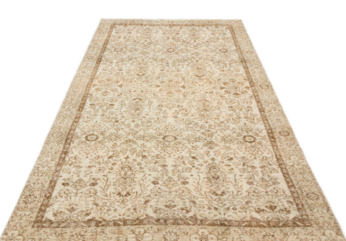 Load image 1 in gallery view. Beige and brown vintage-style rug with a distressed traditional floral medallion pattern on a white background.