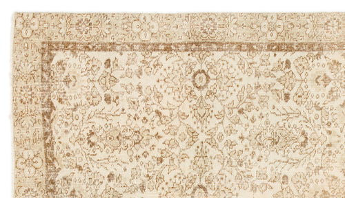 Load image 1 in gallery view. Beige and tan traditional rug with a distressed floral medallion pattern and a decorative border.