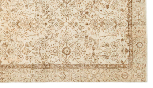 Load image 1 in gallery view. Beige and tan rug with a distressed traditional floral medallion pattern and a bordered edge.