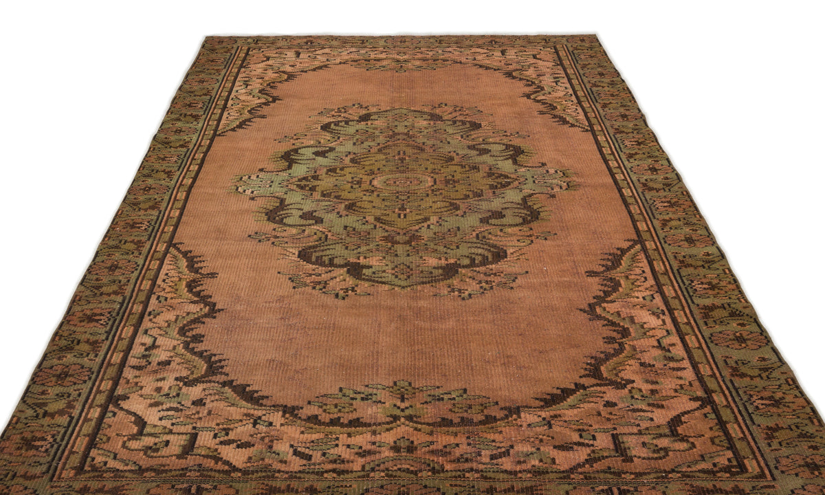 Terracotta and sage green traditional rug with a central medallion and ornate border pattern on a white background.