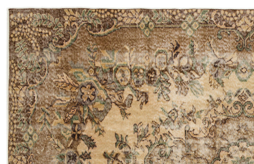 Load image 1 in gallery view. Distressed brown and beige traditional rug with faded floral and vine motifs.