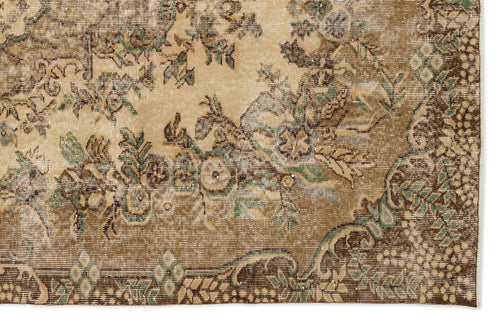 Load image 1 in gallery view. Distressed tan and brown rug with a faded floral medallion pattern and sage green accents.