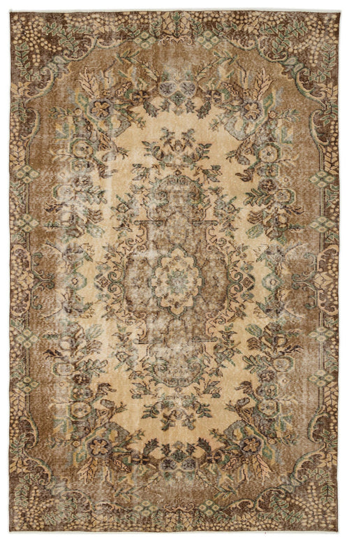 Load image 1 in gallery view. Distressed brown and beige vintage-style rug with a central floral medallion and ornate border.