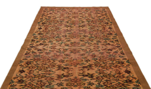 Load image 1 in gallery view. Terracotta and green vintage-style rug with a repeating floral medallion pattern and a solid brown border.