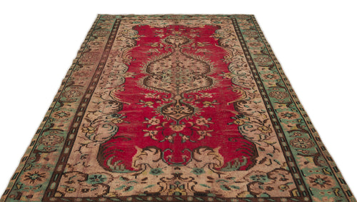 Load image 1 in gallery view. Distressed red, beige, and green vintage-style rug with a central floral medallion and ornate border.