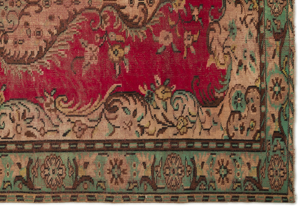 Traditional Persian-style rug with a red field, beige floral motifs, and a green border with geometric accents.