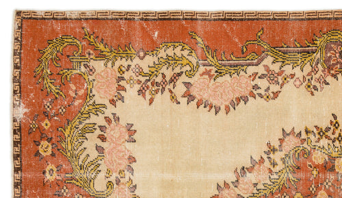 Load image 1 in gallery view. Terracotta and beige vintage-style rug with a floral border, geometric edge detail, and distressed texture.