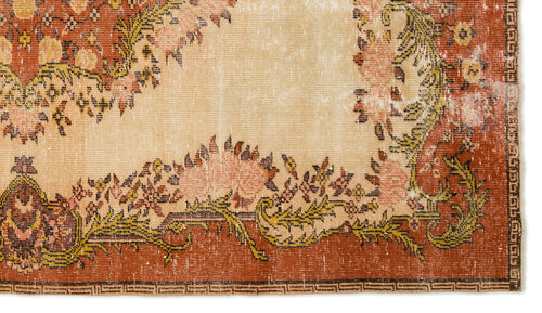 Load image 1 in gallery view. Distressed terracotta and beige rug with a floral medallion pattern and a geometric border.