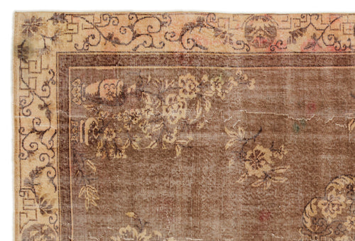 Load image 1 in gallery view. Brown and beige vintage-style rug with a floral medallion pattern and a decorative scrolled border.