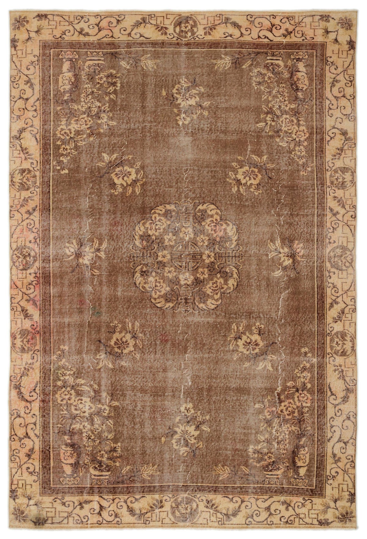 Brown and beige vintage-style rug with a central floral medallion and a decorative geometric border.