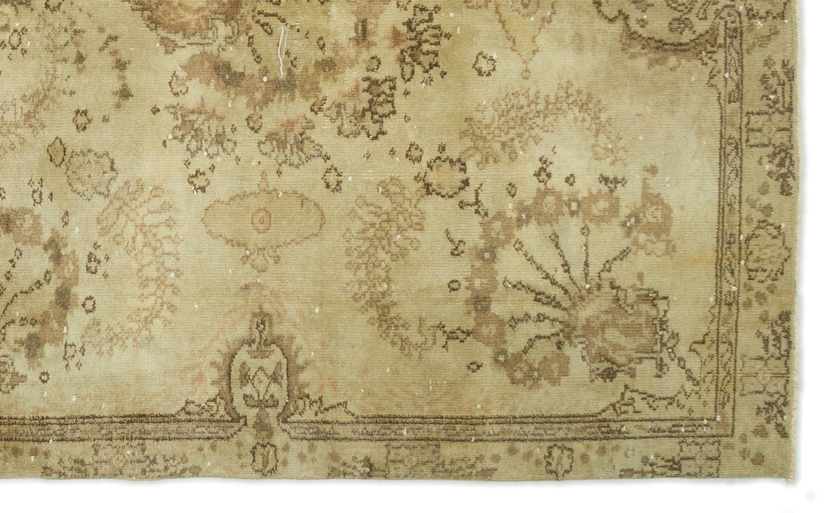 Beige and brown vintage-style rug with a distressed floral medallion pattern and a decorative border.