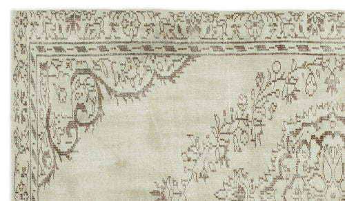 Load image 1 in gallery view. Beige and taupe vintage-style rug with a distressed floral medallion pattern and a decorative border.