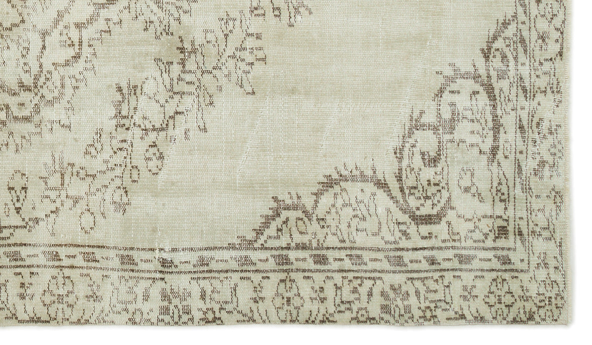 Beige and taupe rug with a distressed traditional floral medallion pattern and a detailed border.