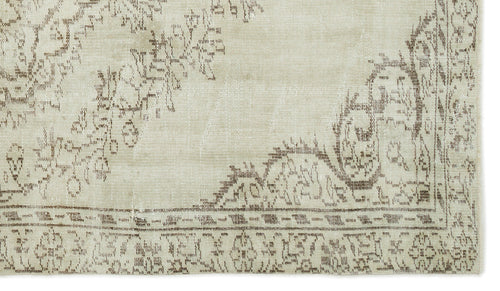 Load image 1 in gallery view. Beige and taupe rug with a distressed traditional floral medallion pattern and a detailed border.